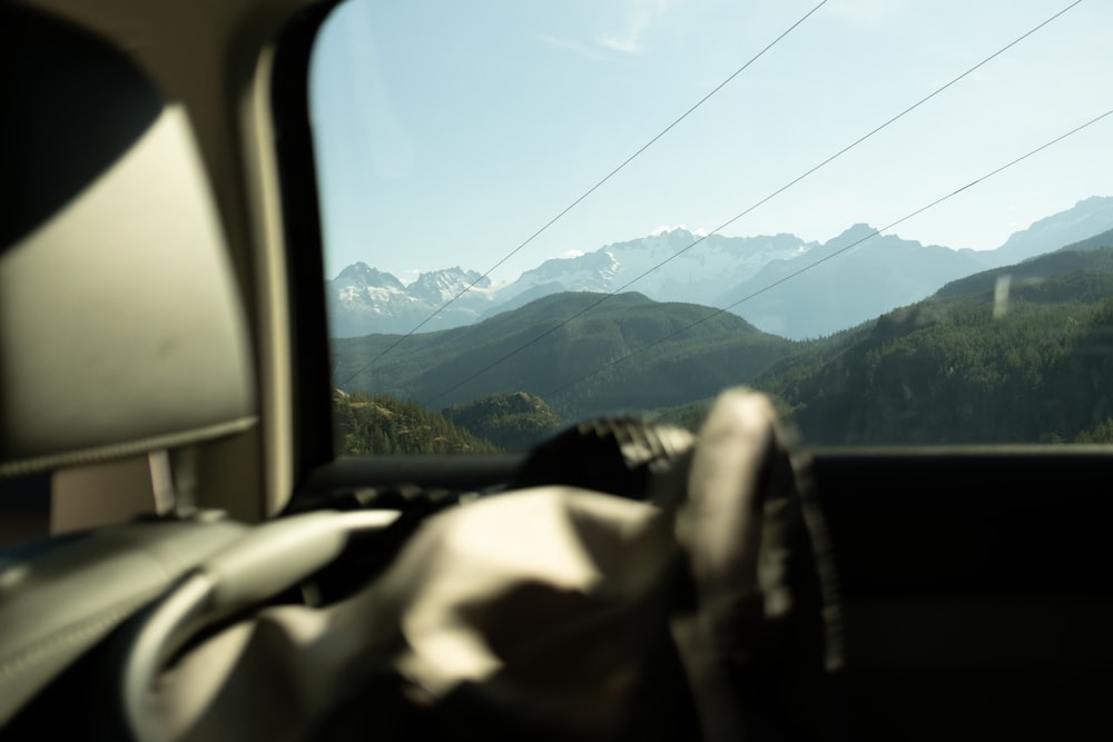 a view of a mountain range from inside a car