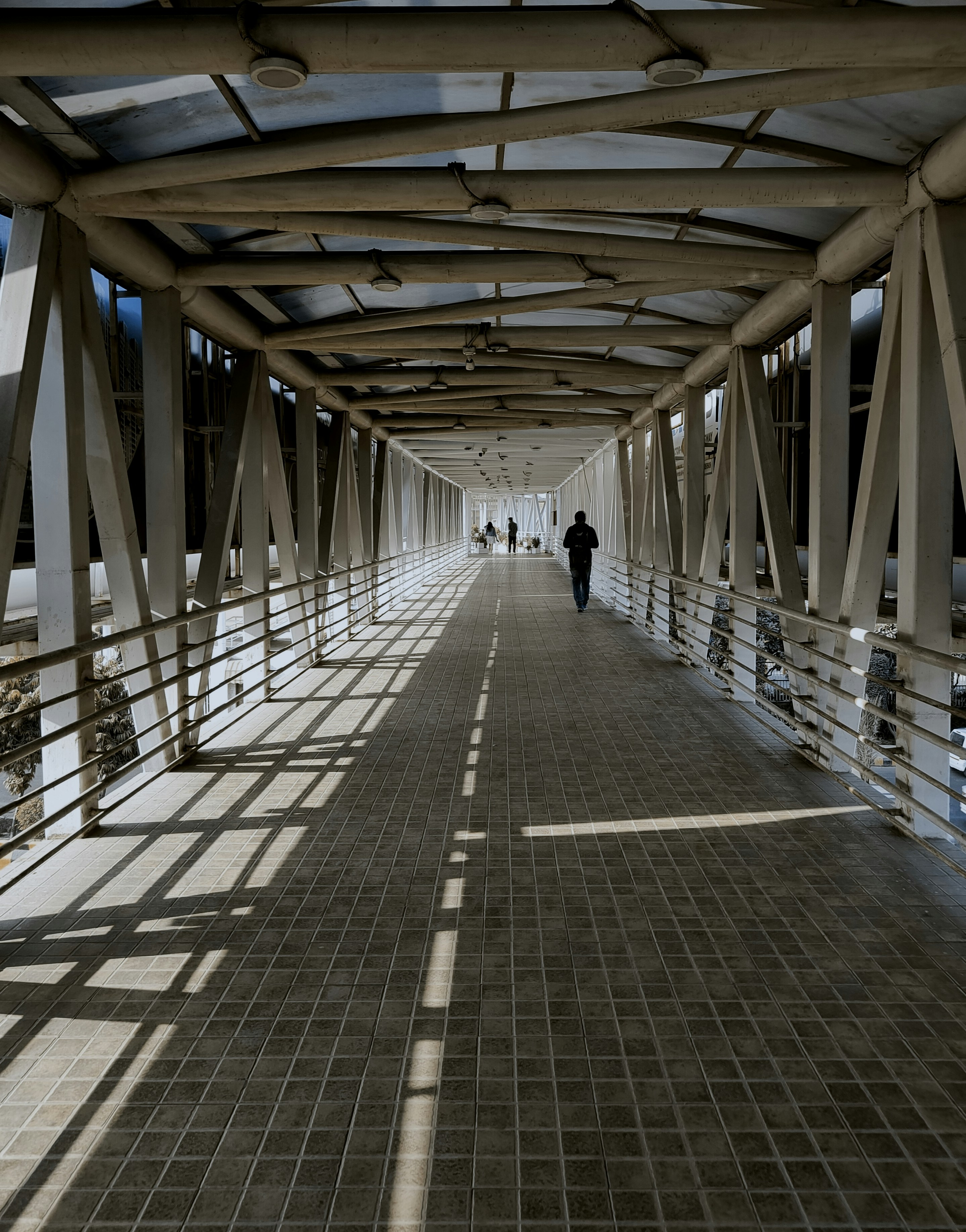 a person is walking down a long walkway