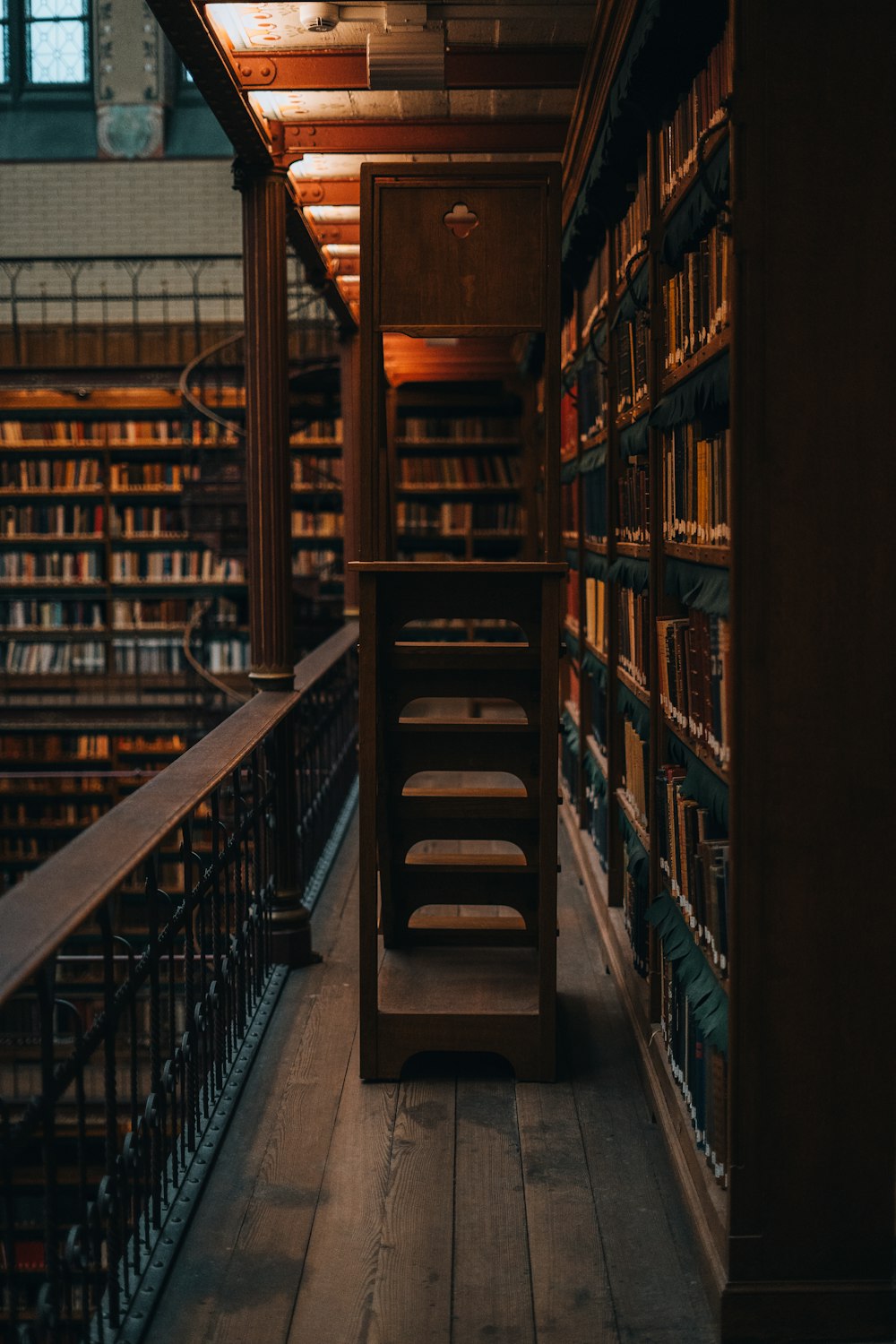 a long wooden shelf filled with lots of books