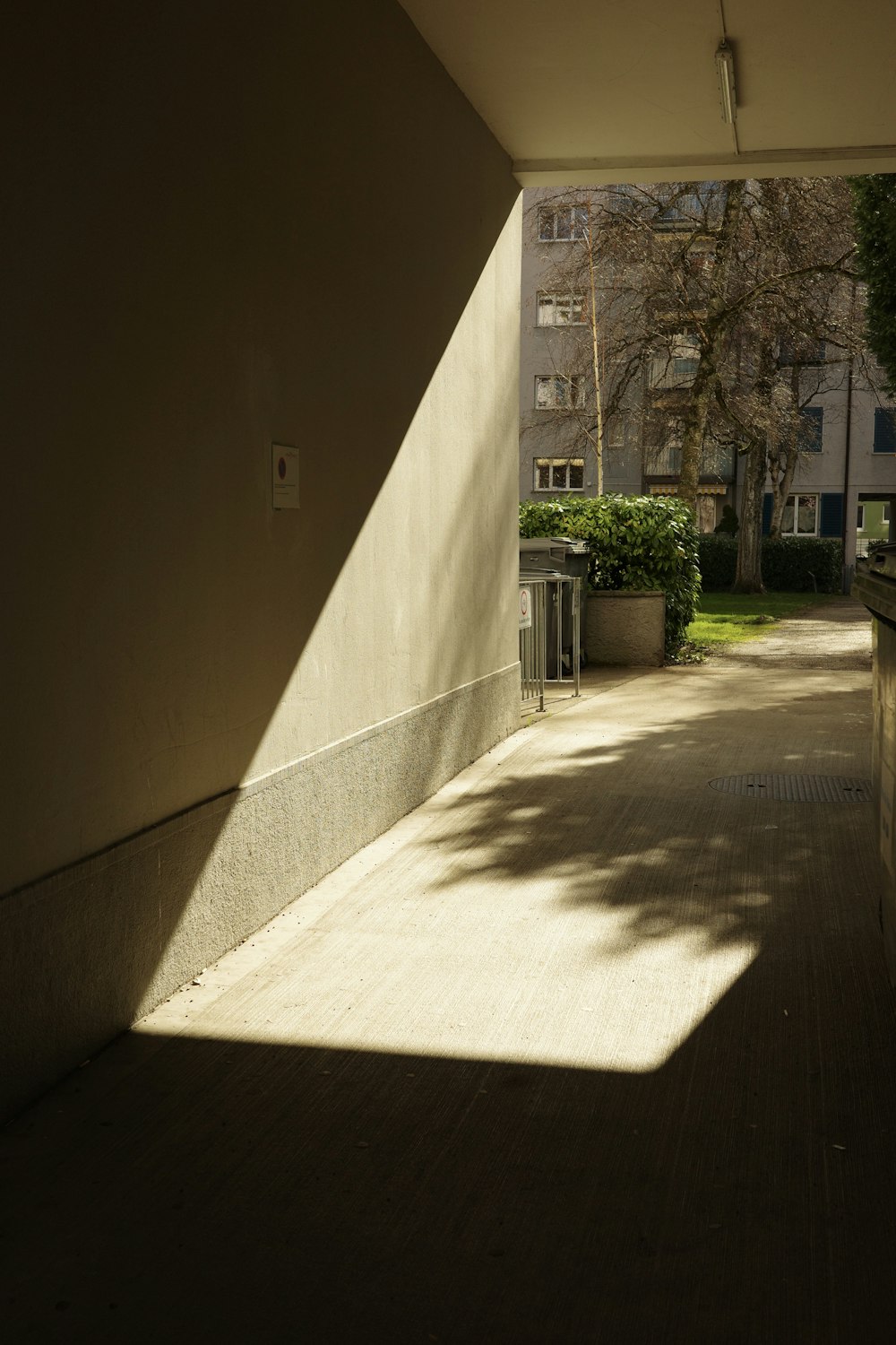 the sun shines through a window onto a sidewalk