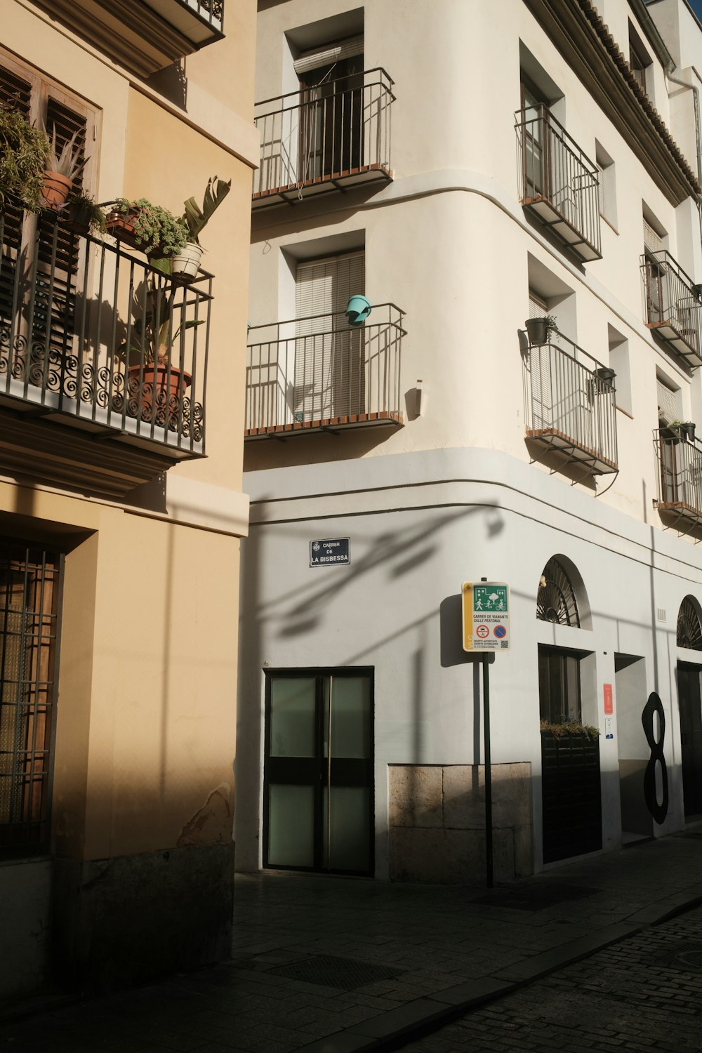 a tall white building with balconies and balconies