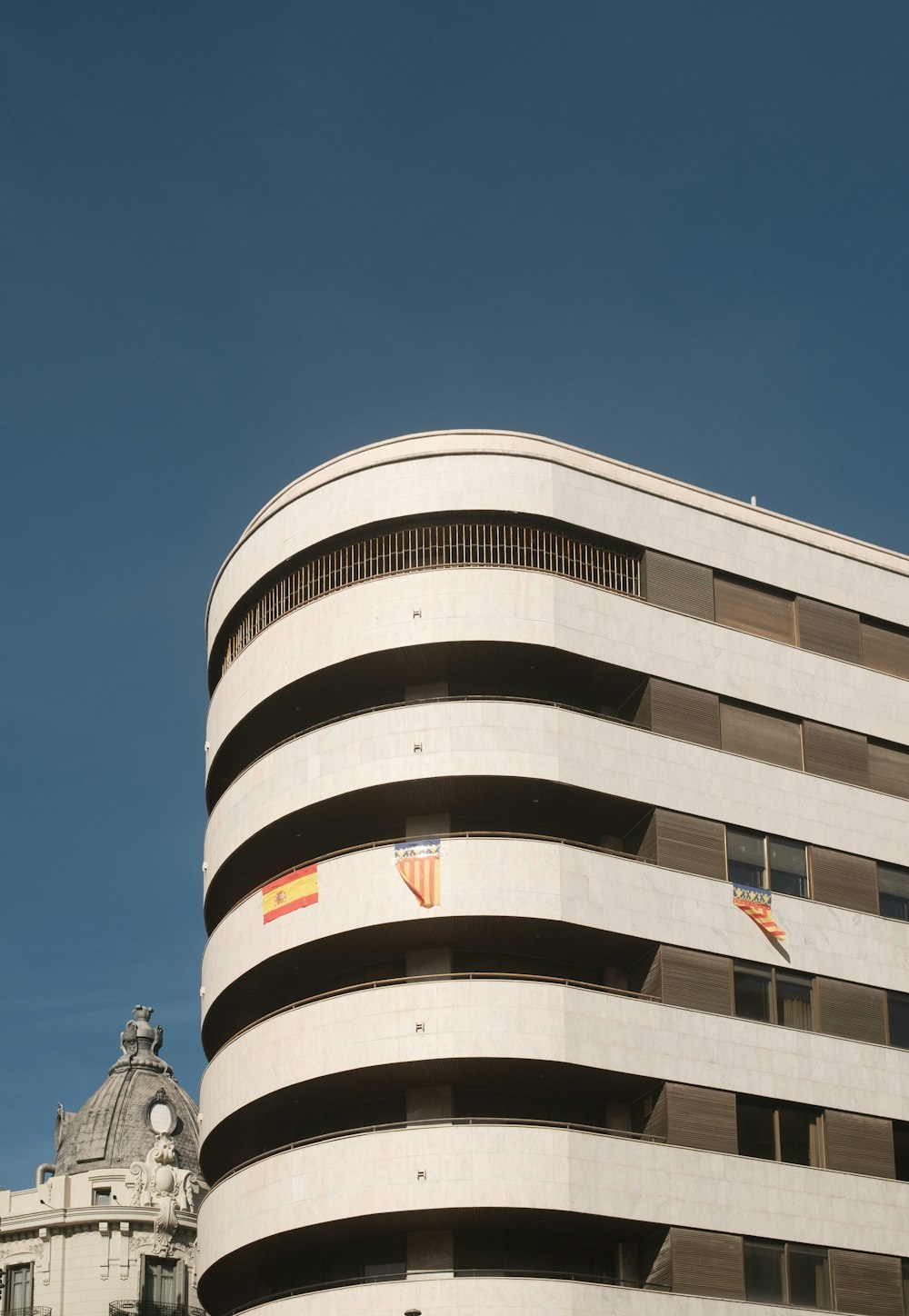 a large white building with a clock on it's side