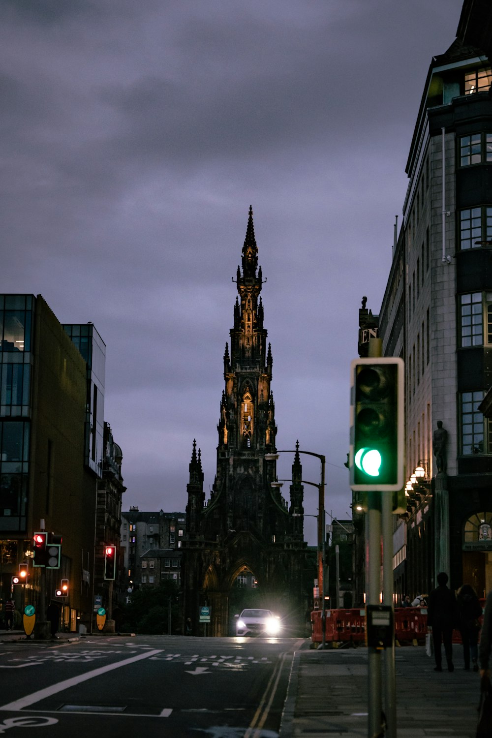 a green traffic light sitting on the side of a road