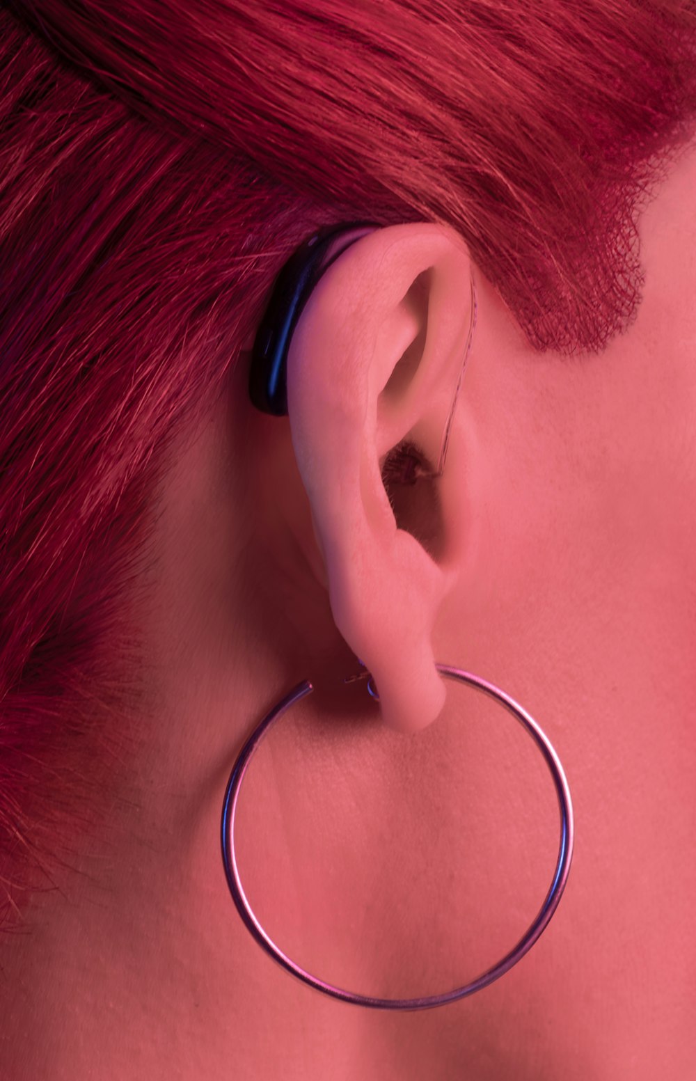 a close up of a person wearing a pair of earrings