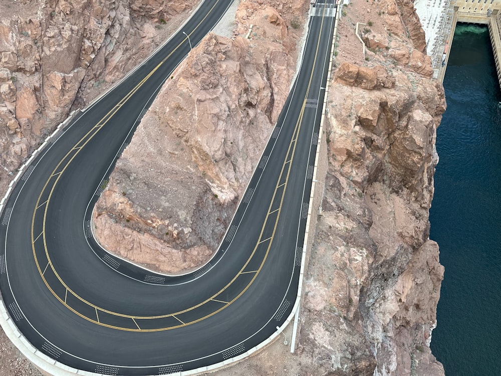 an aerial view of a winding road in the mountains