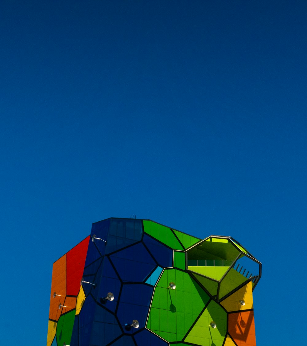 a colorful kite flying in a blue sky