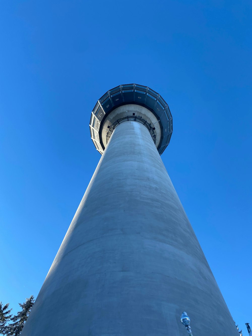 a tall white tower with a blue sky in the background