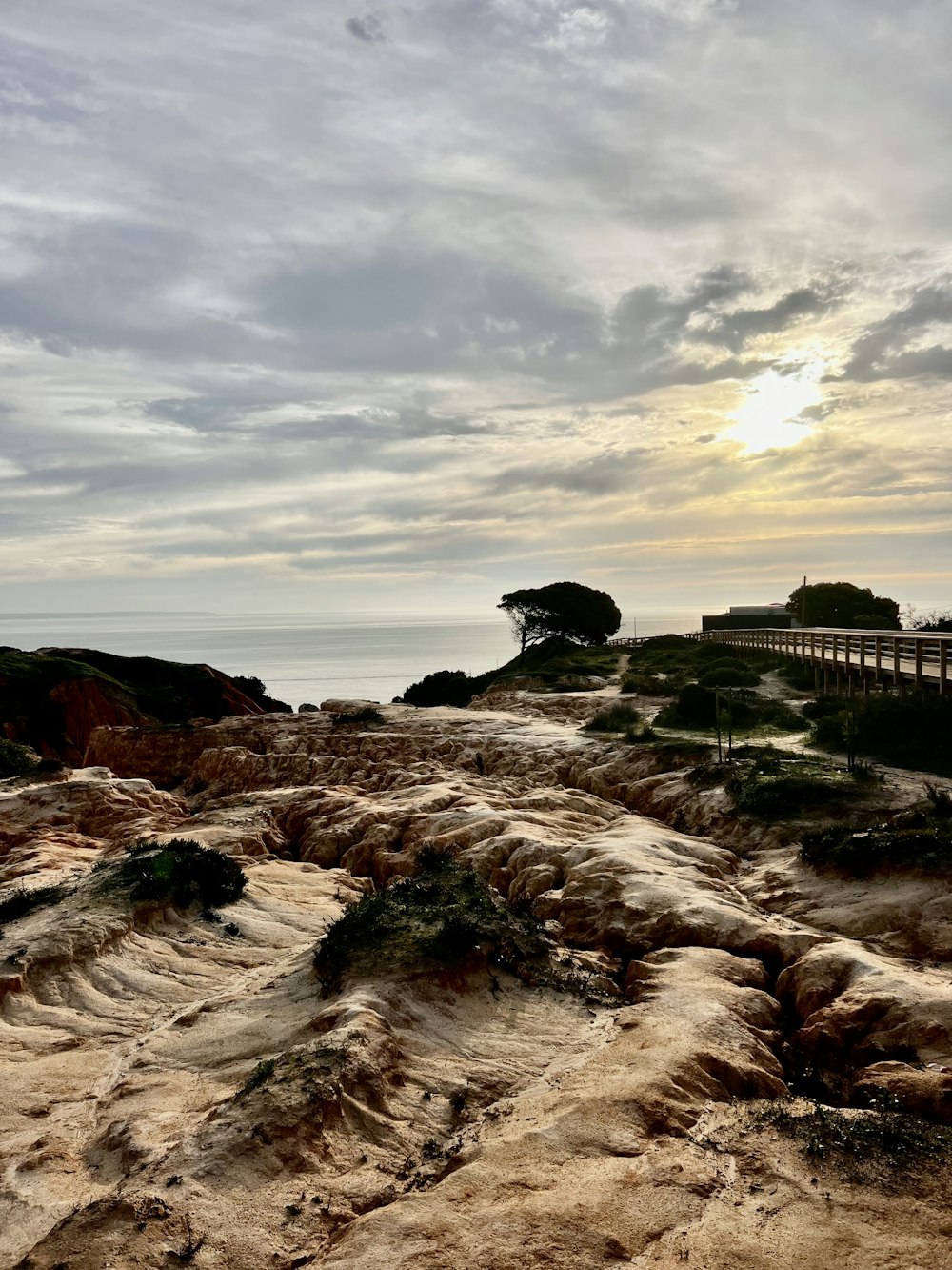 the sun is setting over a rocky beach