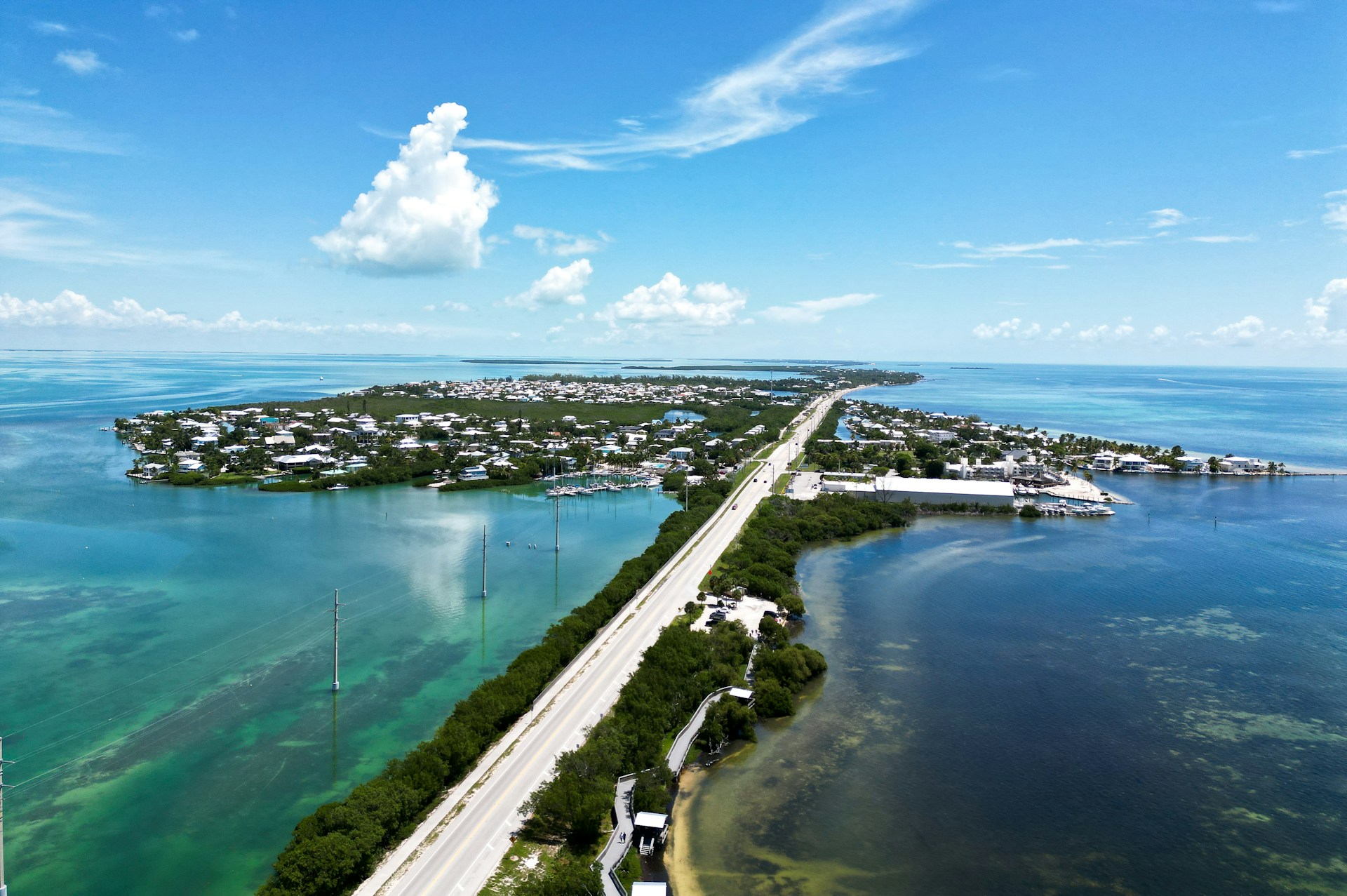 an aerial view of a highway and a body of water