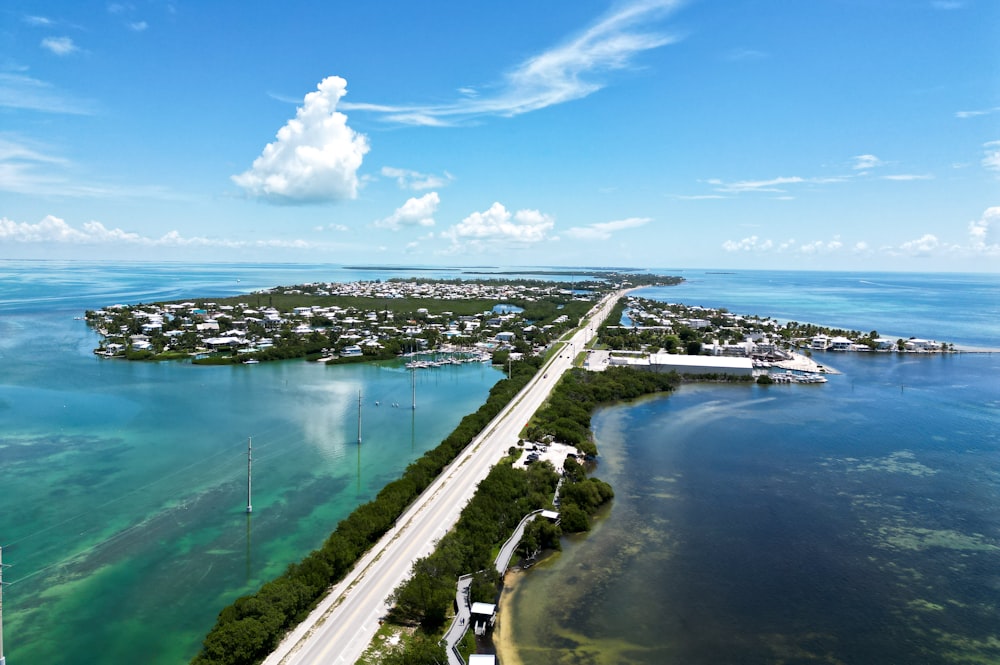 an aerial view of a highway and a body of water