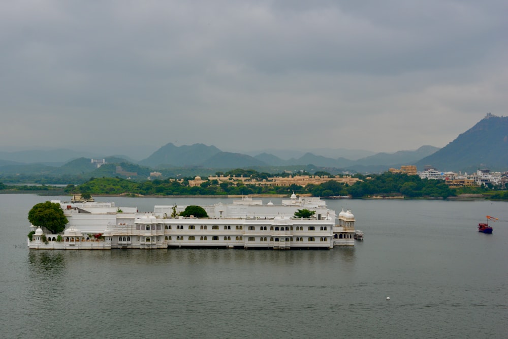 a large white boat floating on top of a lake