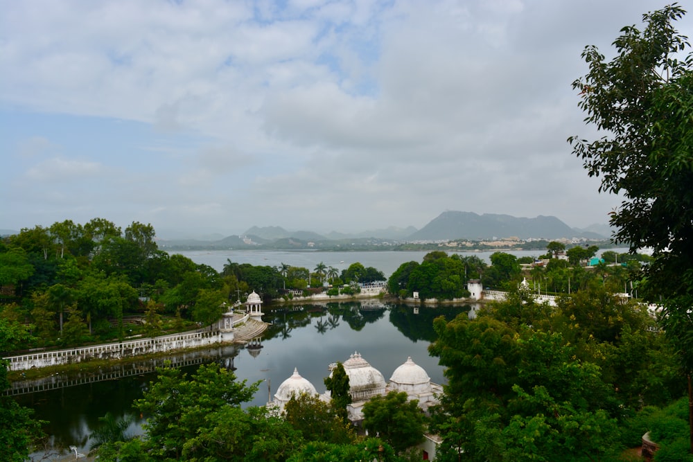 a body of water surrounded by trees and mountains