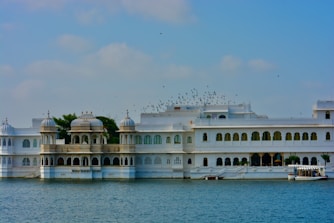 a large white building sitting on top of a body of water