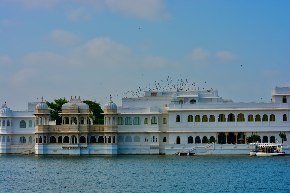 a large white building sitting on top of a body of water