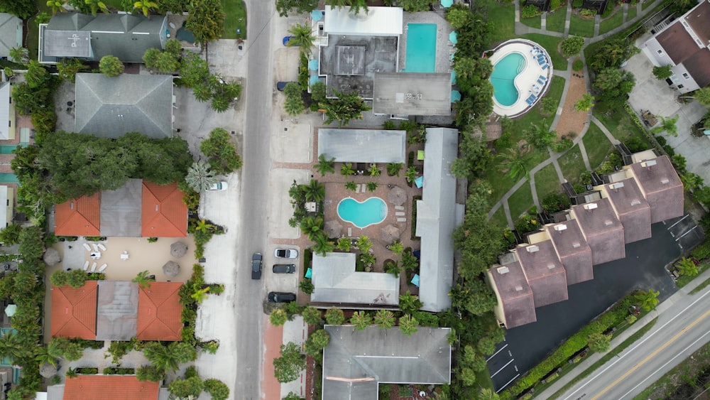 an aerial view of houses and a pool
