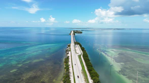 an aerial view of a long stretch of road next to the ocean