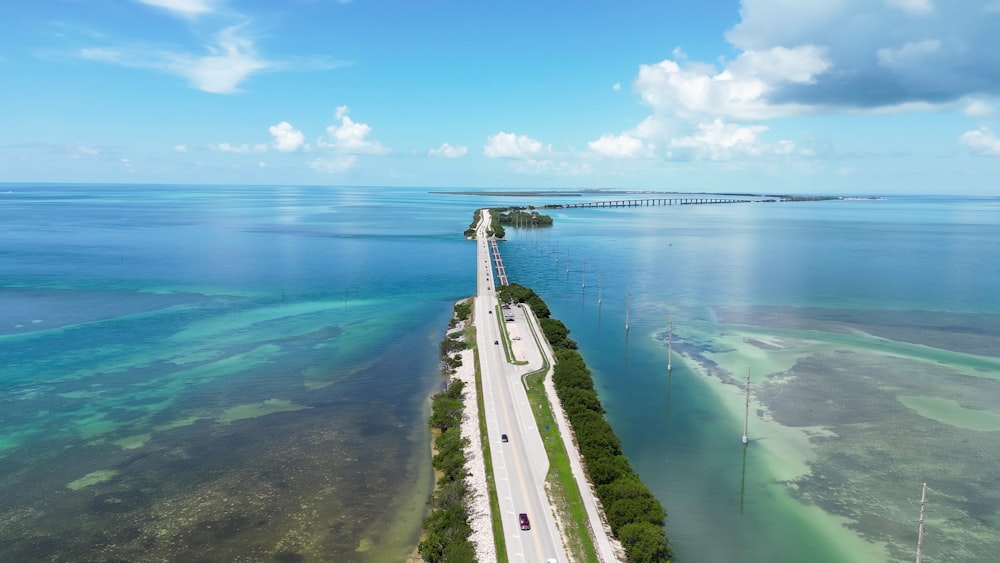 an aerial view of a long stretch of road next to the ocean