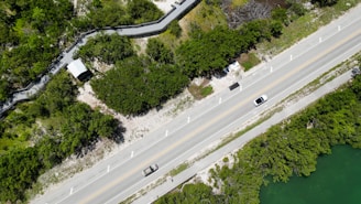 an aerial view of a road and a river