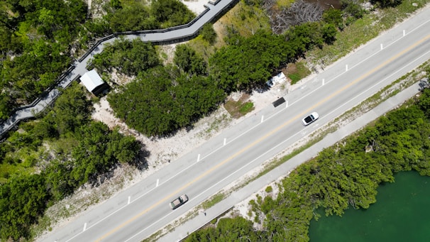 an aerial view of a road and a river