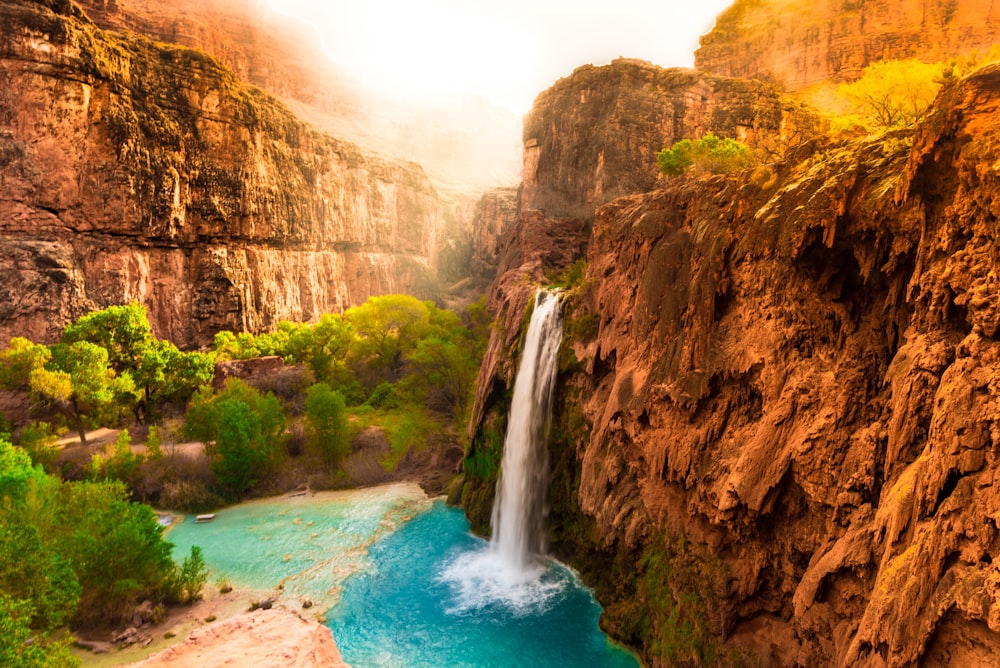 a waterfall in the middle of a canyon