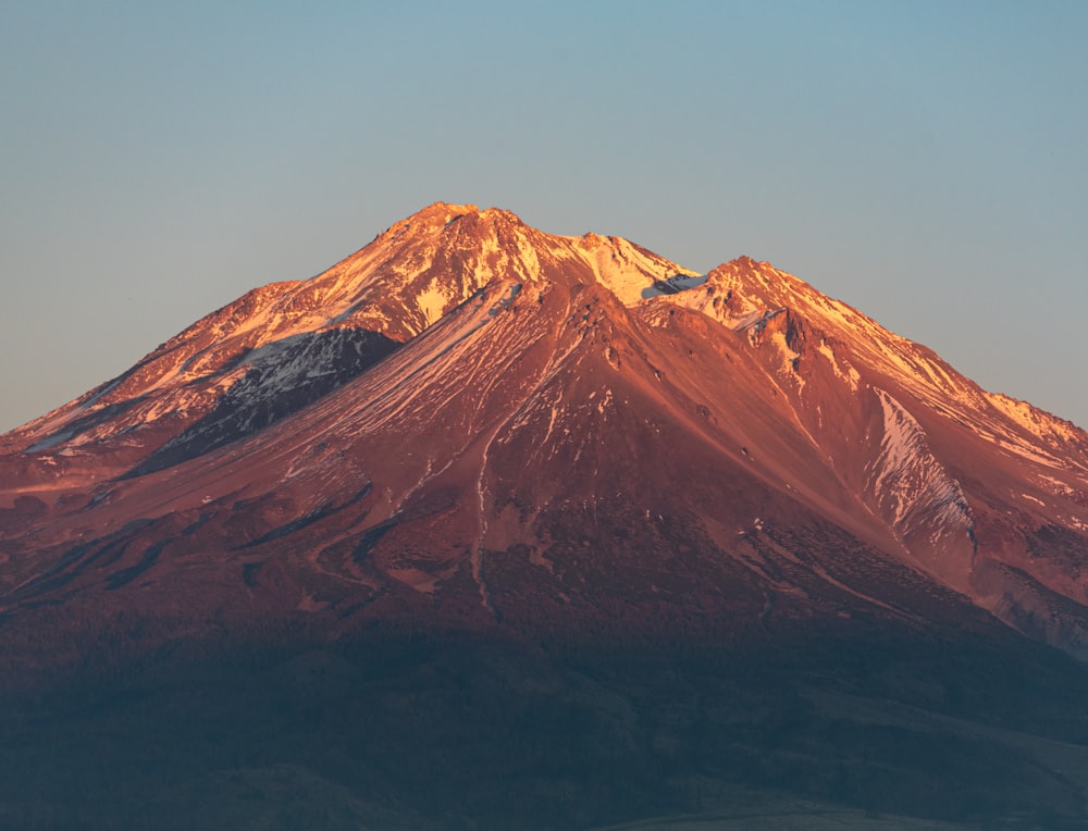 a large mountain with snow on top of it