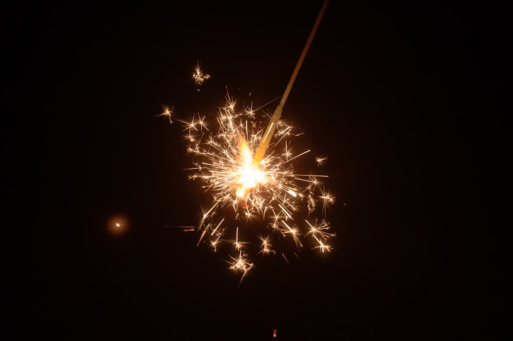 a fireworks is lit up in the night sky