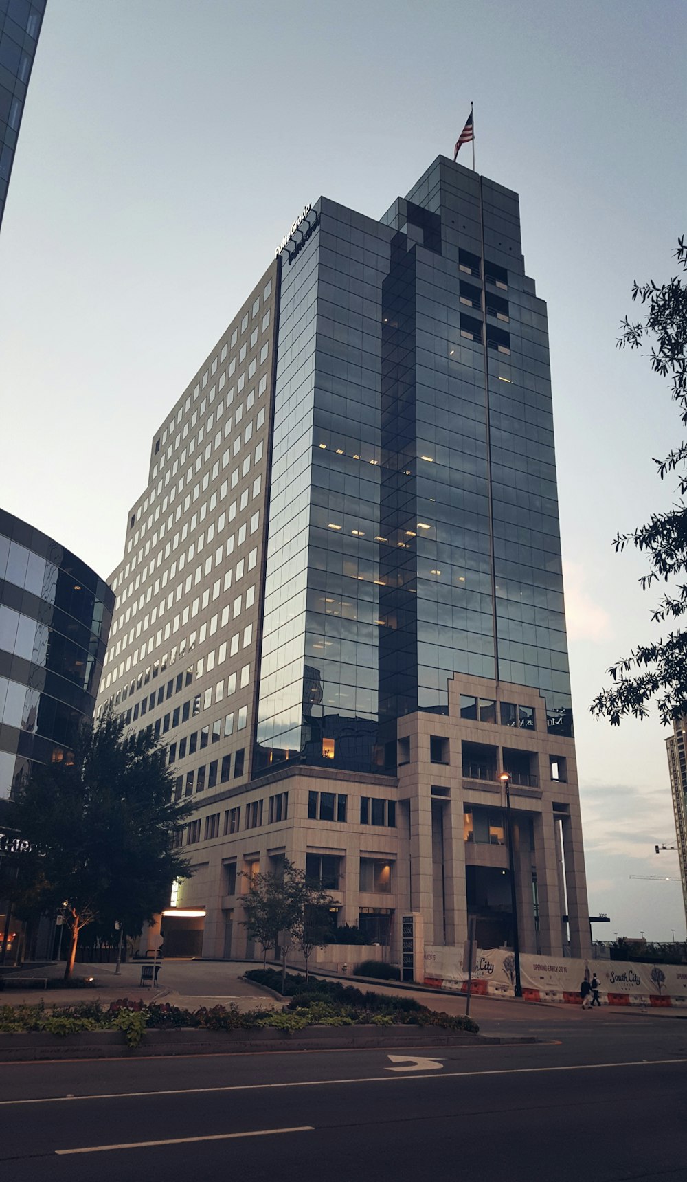 a very tall building with a flag on top of it