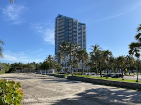 an empty parking lot in front of a tall building