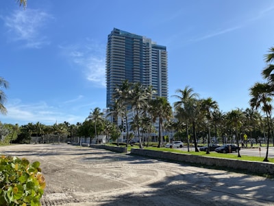 an empty parking lot in front of a tall building