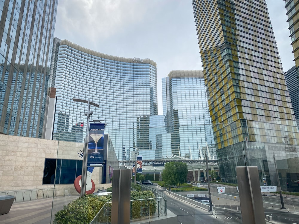 a city street with tall buildings in the background