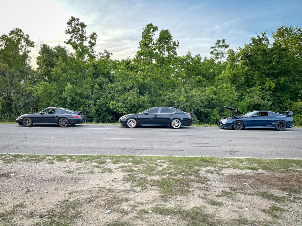 three cars parked on the side of the road