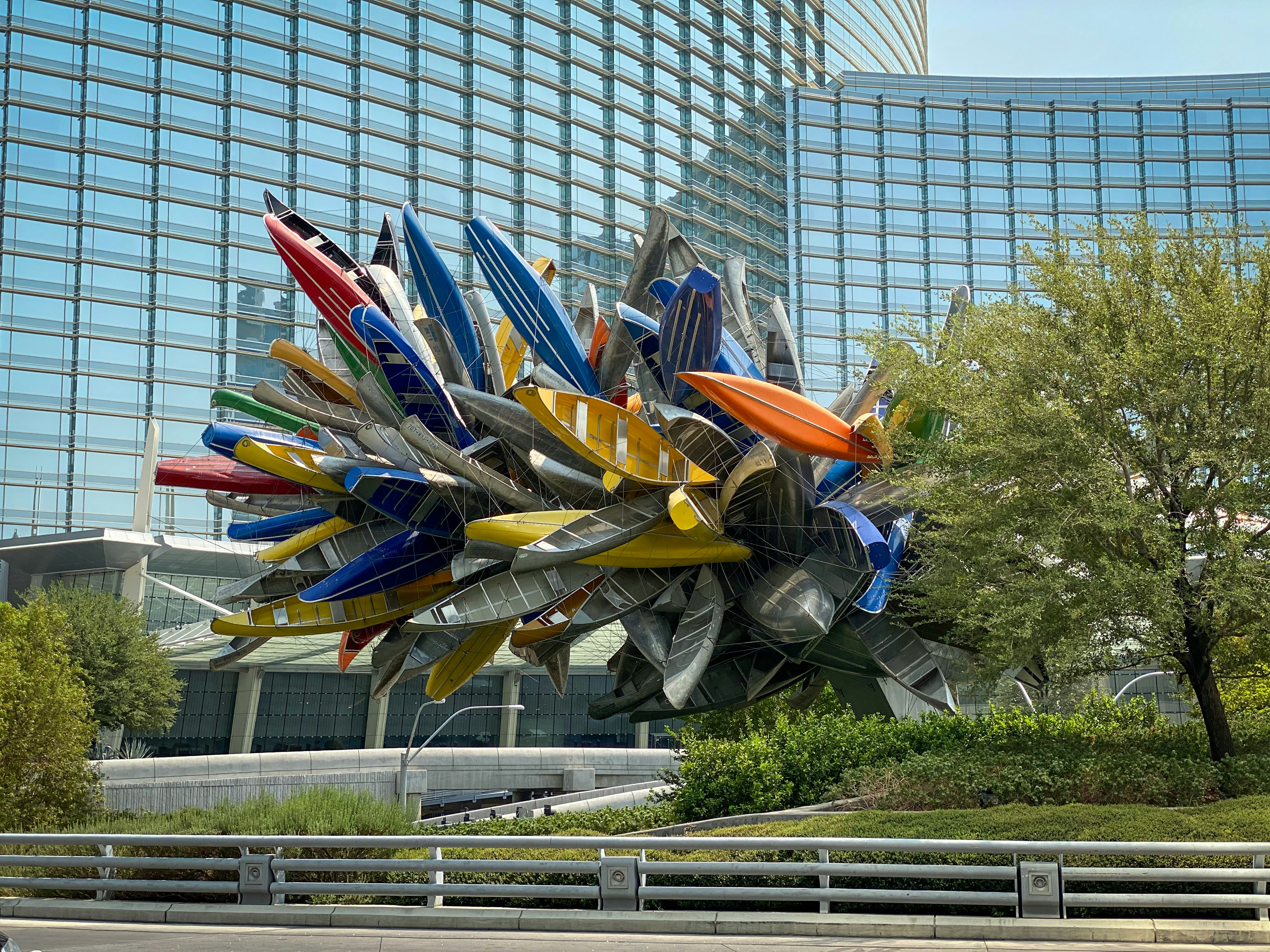 a sculpture in front of a large building, 