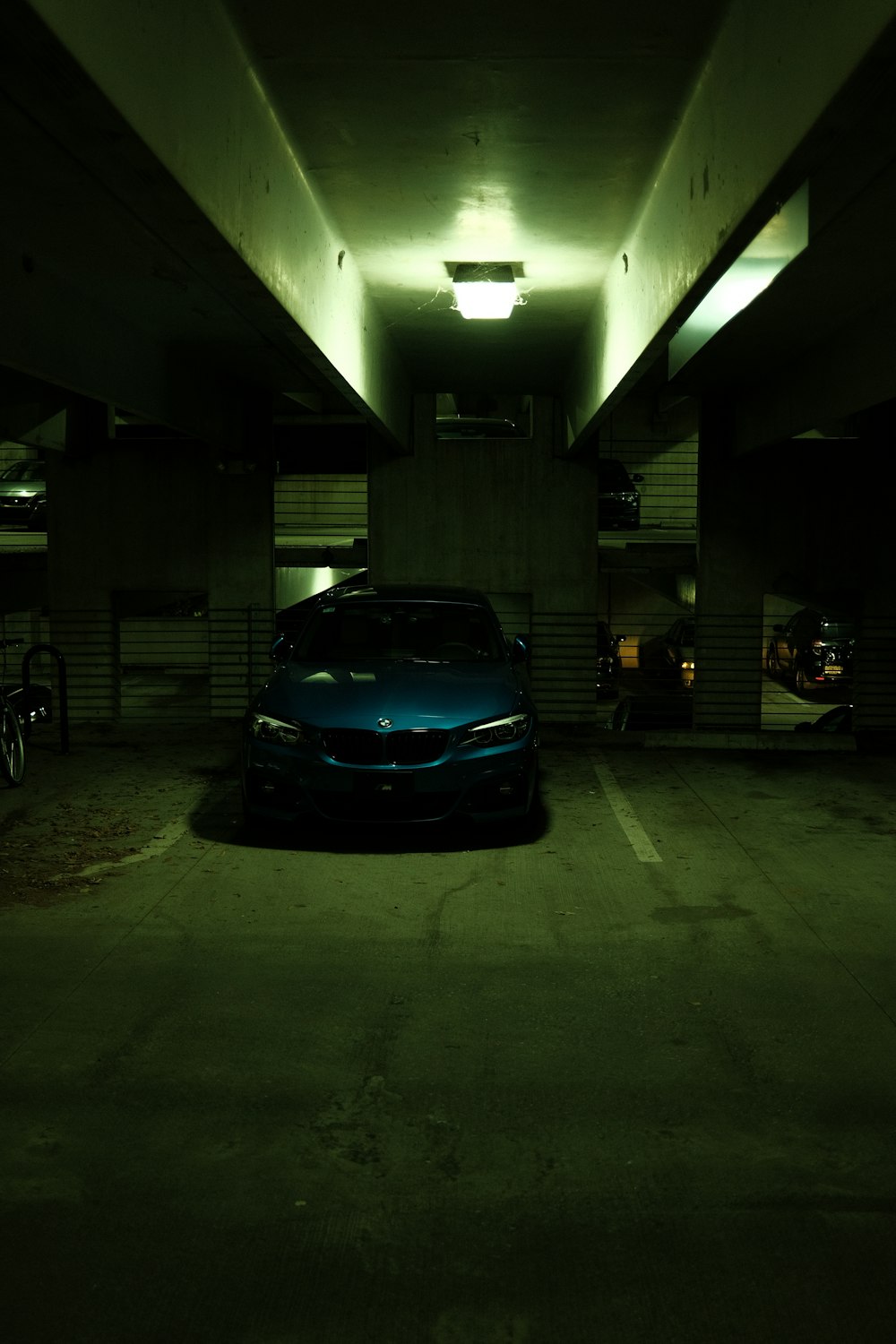 a car parked in a parking garage at night