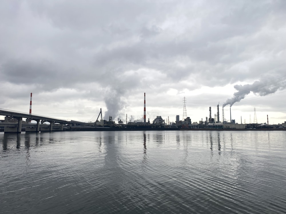 a large body of water with a bridge in the background