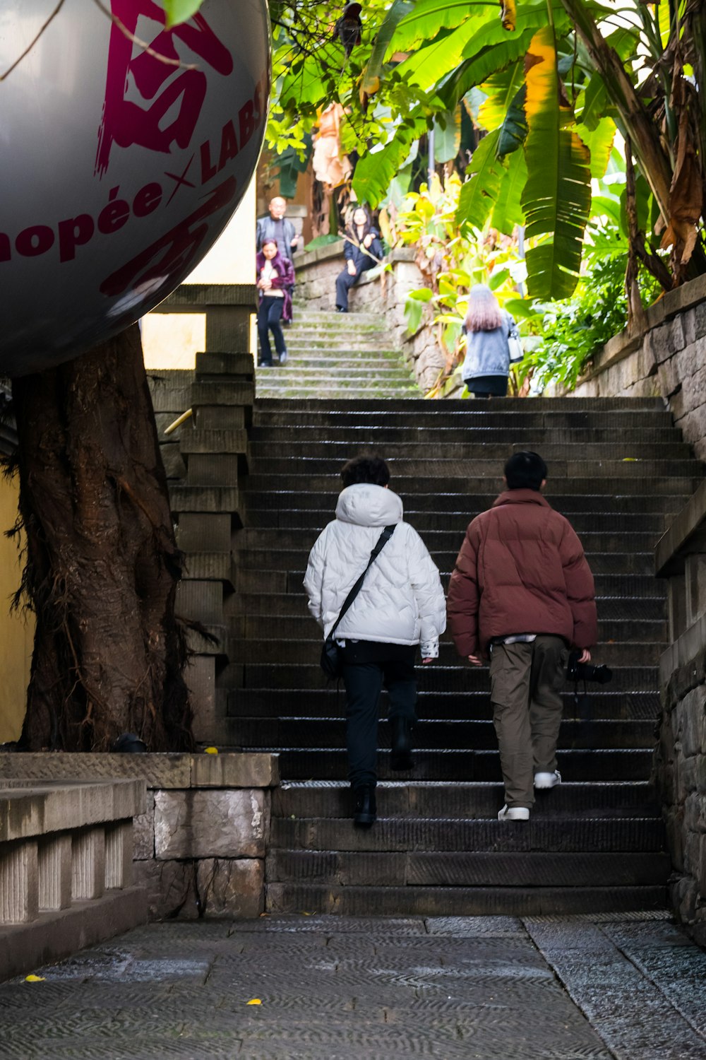 two people walking up a flight of stairs