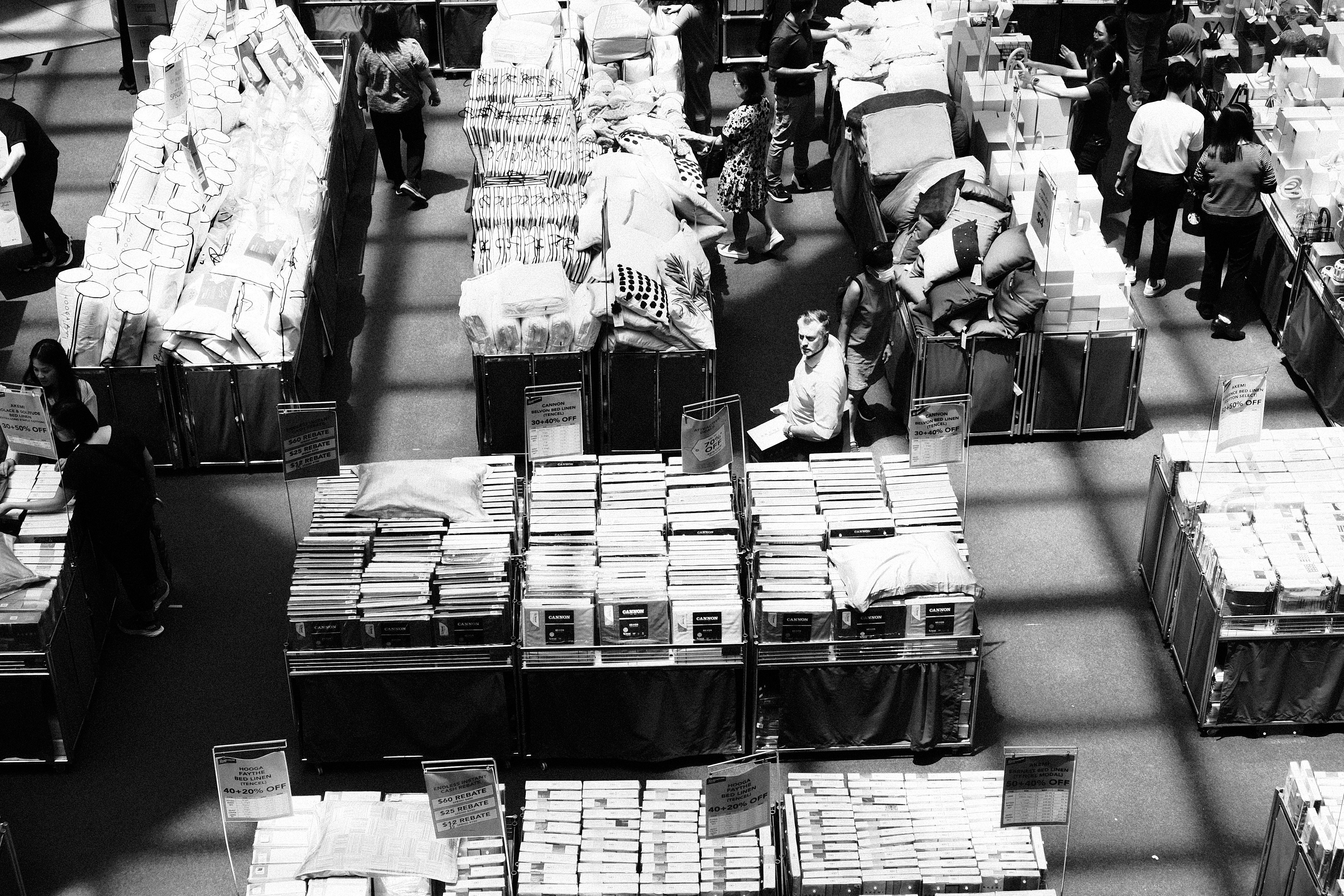 a black and white photo of people and luggage
