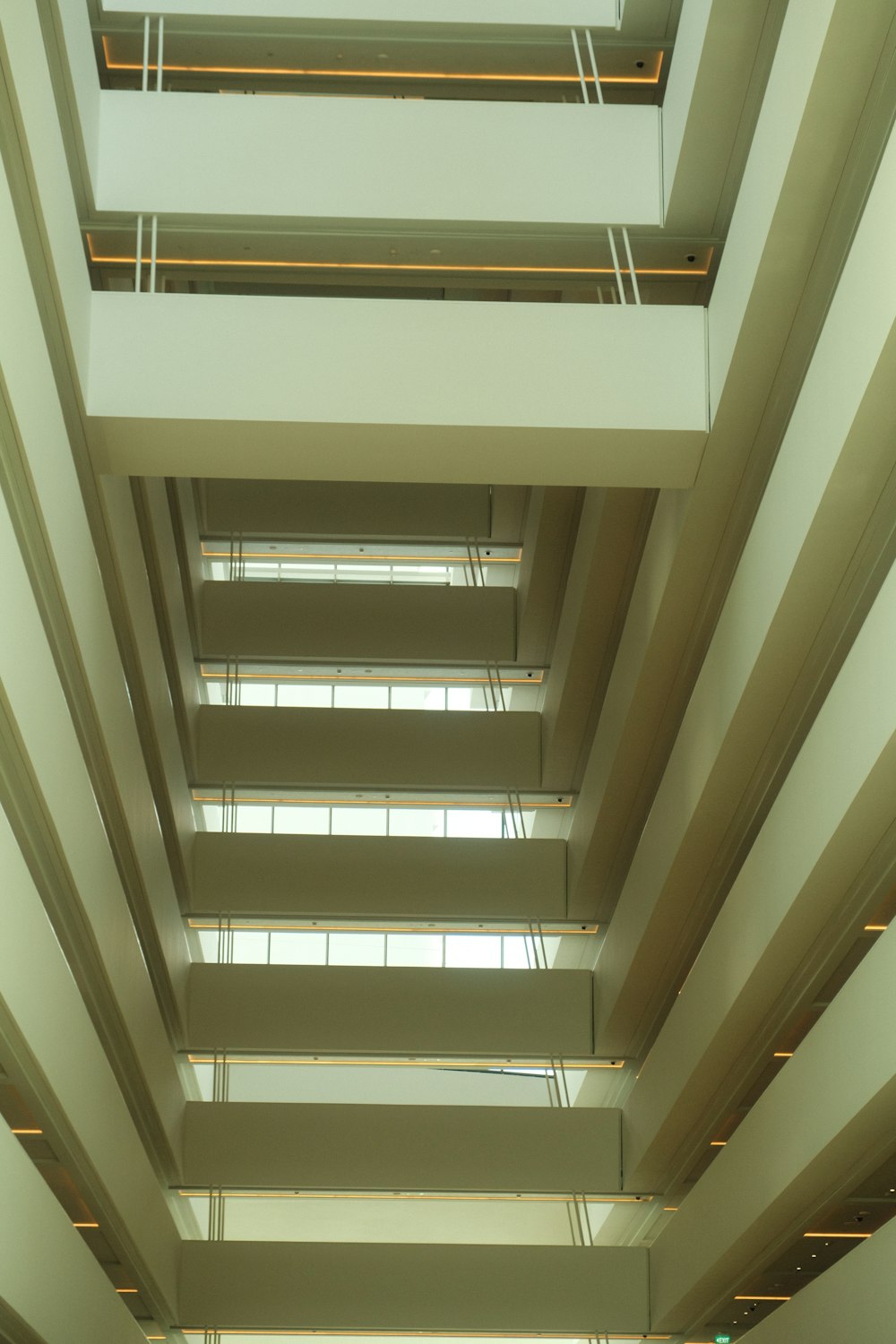 the ceiling of a large building with many windows