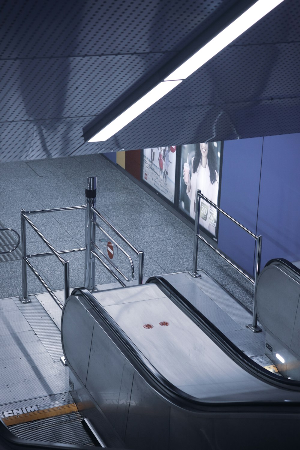 an escalator in a subway station with a person on the escalator