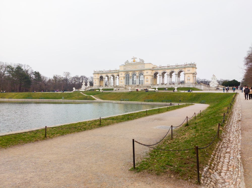 a large building with a pond in front of it