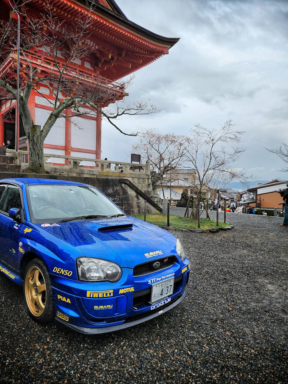 a blue car parked in front of a building