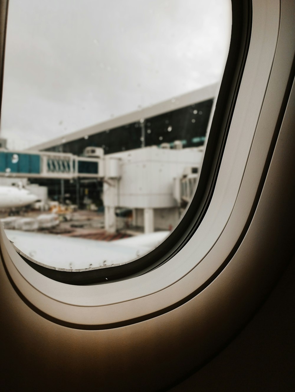 an airplane window with a view of an airport