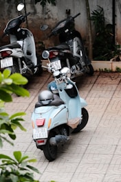 a blue scooter parked next to another scooter
