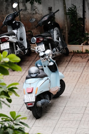a blue scooter parked next to another scooter