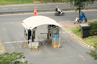 a man riding a motorcycle next to a white tent
