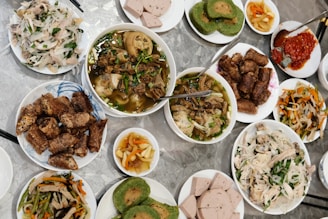 a table topped with lots of plates of food