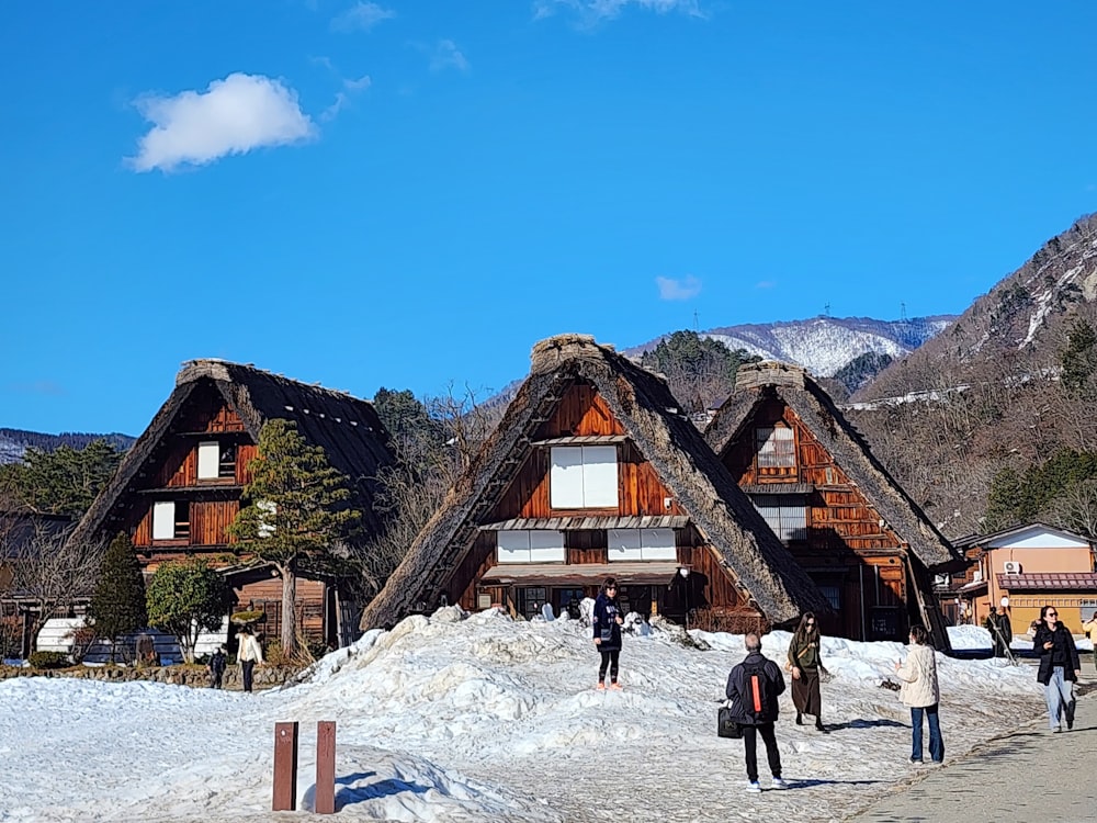 a group of people walking down a snow covered road