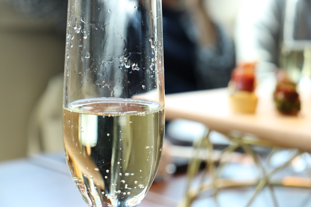 a close up of a glass of wine on a table