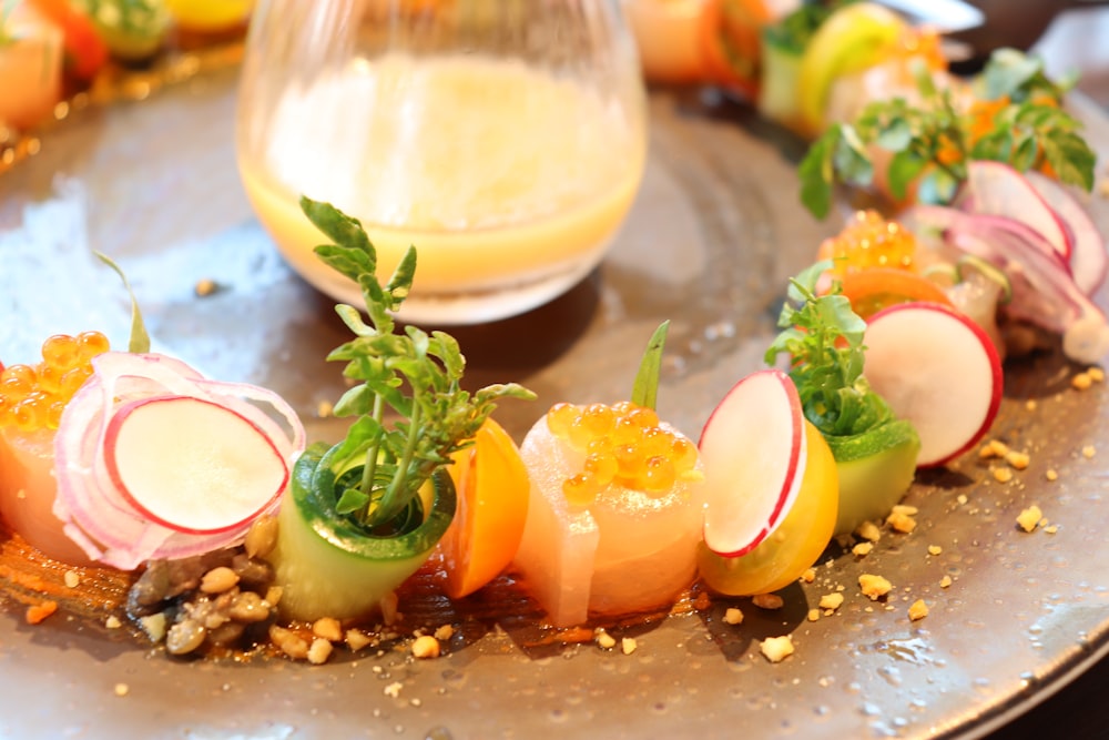 a plate of food on a table with a glass of orange juice