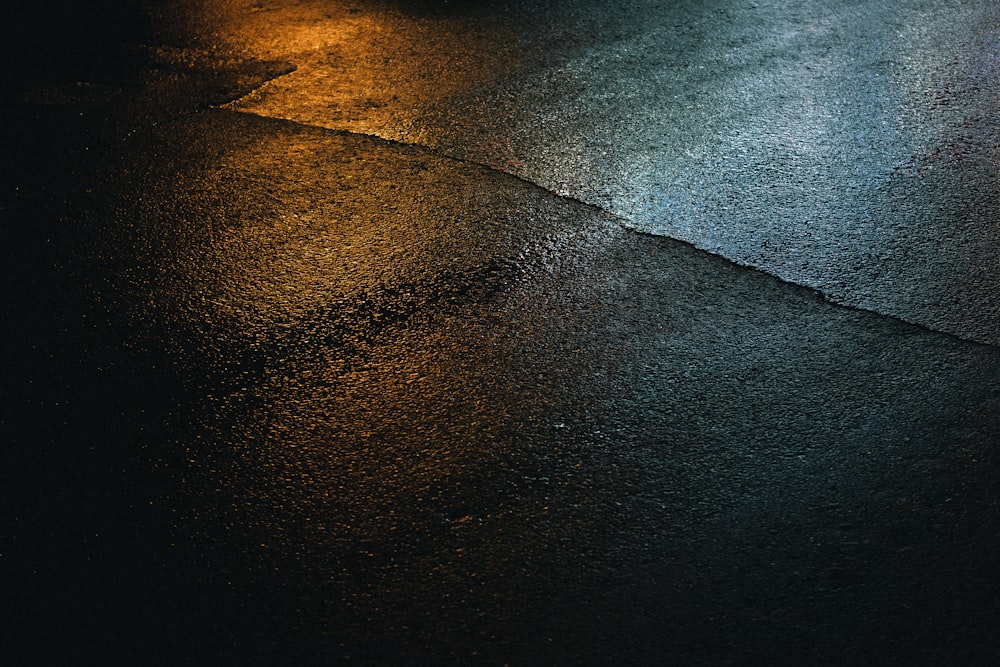 a wet street with a street light in the background