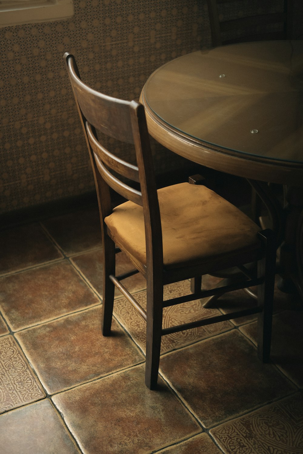 a wooden chair sitting at a round table